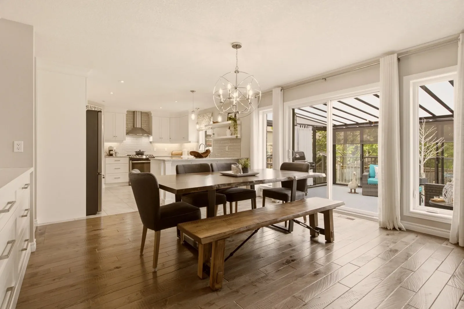 Bright open-concept dining room and white kitchen in an Elora, Ontario home