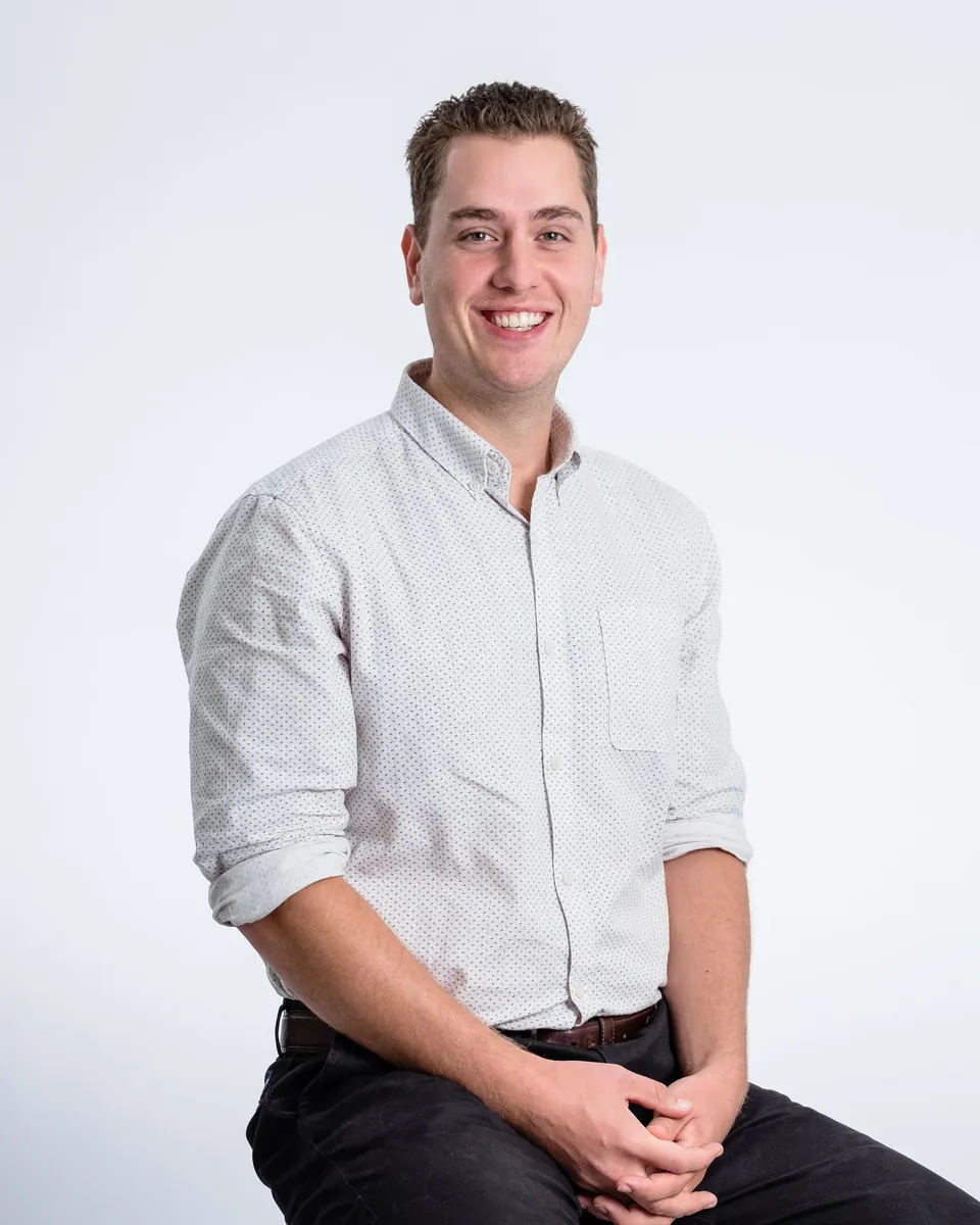 Kris Butler, REALTOR® with M1 Real Estate Brokerage, smiling with hands clasped